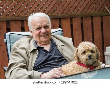 Elderly Man Sitting Down With His Dog