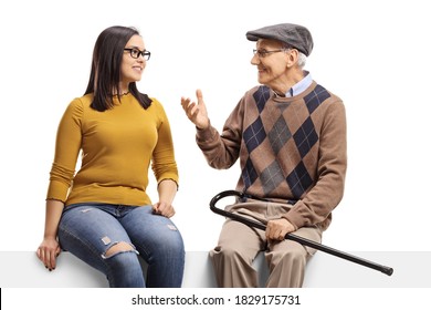 Elderly man sitting on a panel and talking to a young female isolated on white background - Powered by Shutterstock