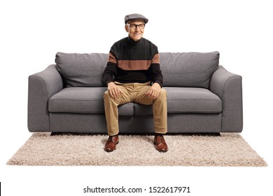 Elderly Man Sitting On A Sofa And Smiling Isolated On White Background