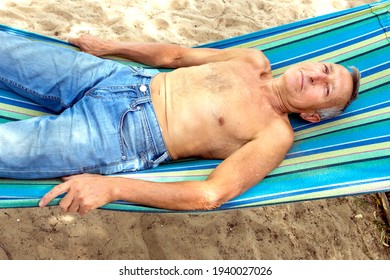 An Elderly Man Sleeping On A Hammock On A Hot Summer Day