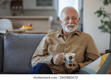 Elderly man, sofa and tea to relax with drink for peace, quiet and me time to start morning in house. Senior men, couch and tea for happiness, thinking and memory from aroma in home living room. - Powered by Shutterstock