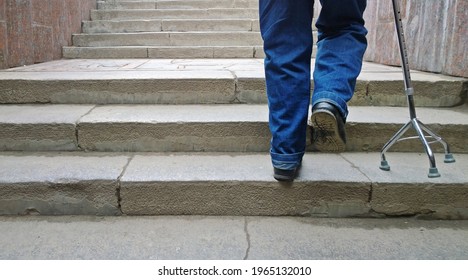 Elderly man with support cane stepping up stairs - Powered by Shutterstock