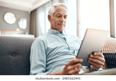 Elderly man, tablet and retirement in home for typing email, communication and reading online news. Senior person, technology and relax on sofa in lounge for bills payment, webinar and writing ebook - Powered by Shutterstock