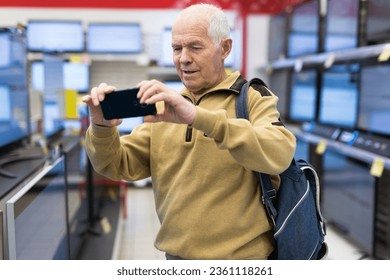 Elderly man takes pictures of modern digital - Powered by Shutterstock