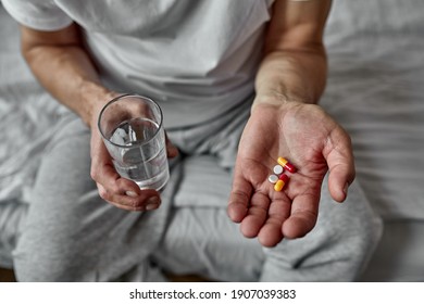 Elderly Man Taking Pills, Closeup. Many Pills In Hands. Caring For The Health Of The Elderly. Health Issues At An Old Age, Taking Several Medicines.