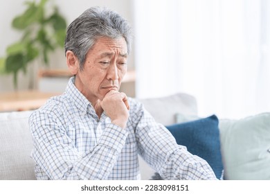 Elderly man thinking in the room