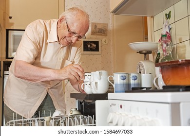 Elderly Man Unloading the Dishwasher