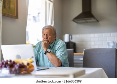 Elderly man using laptop at kitchen table
 - Powered by Shutterstock