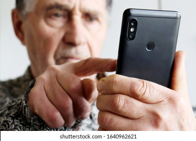 Elderly man using smartphone, mobile phone in male hands close up. Concept of online communication in retirement, sms, social media - Powered by Shutterstock