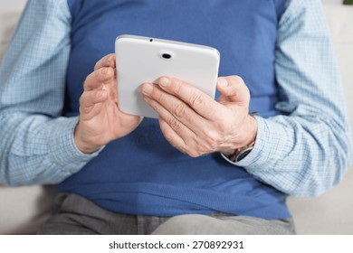 Elderly man using tablet at work