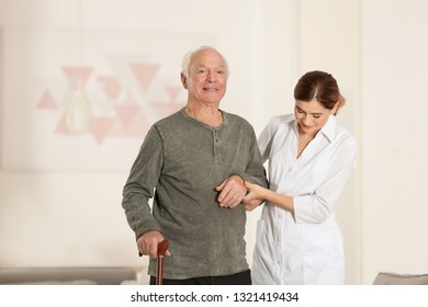 Elderly Man Walking Cane Female Caregiver Stock Photo (Edit Now) 1321419446