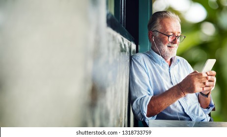 Elderly Man Watching Online Movie From His Phone