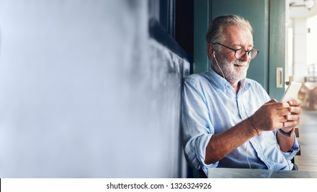 Elderly man watching online movie from his phone