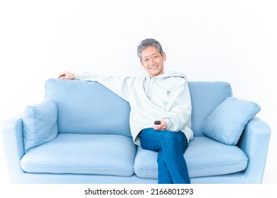 An Elderly Man Watching TV At Home