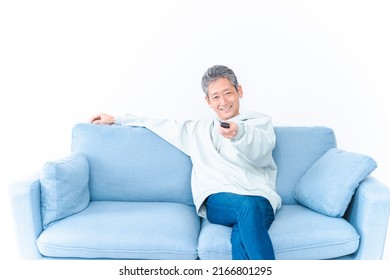 An Elderly Man Watching TV At Home