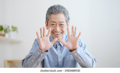 Elderly Man Waving In A Video Call