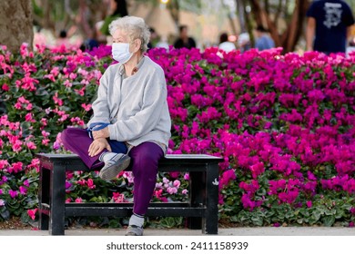 
Elderly man wearing mask in purple flower garden. - Powered by Shutterstock