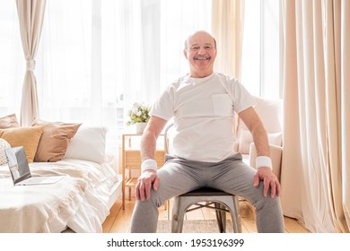 Elderly Man Wearing Sport Clothing Sitting On Chair Ready For Online Yoga Lesson