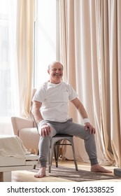 Elderly Man Wearing Sport Clothing Sitting On Chair Ready For Online Yoga Lesson