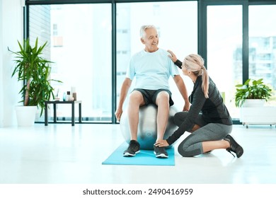 Elderly man, woman and physiotherapy in workout or training in senior care, retirement and fitness center for healing. Physiotherapist, patient and exercise in yoga ball, rehabilitation and trainer - Powered by Shutterstock