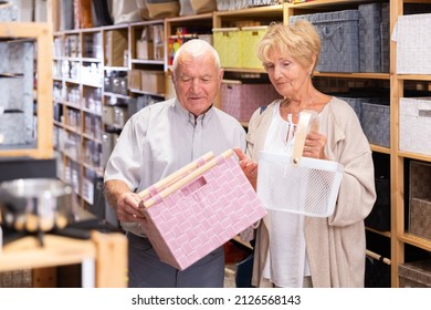 Elderly Man And Woman Searching Storage Basket At Home Decor Store