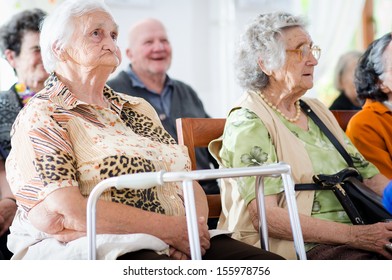 elderly man and woman sitting 