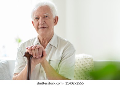 Elderly Man With Wooden Walking Stick In The Nursing House