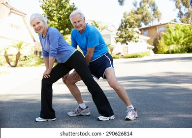 Elderly Man And Younger Woman Jogging