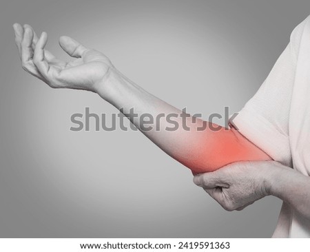 Elderly man's arm feeling elbow pain_Pain inside the elbow, concept of lateral epicondylitis of the elbow