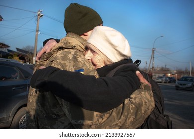 Elderly mother says goodbye to her military son. Mom hugs a Ukrainian soldier. Militarization. Ukrainian defender says goodbye to his family. Mobilization of Ukrainian men. War of Ukraine and Russia