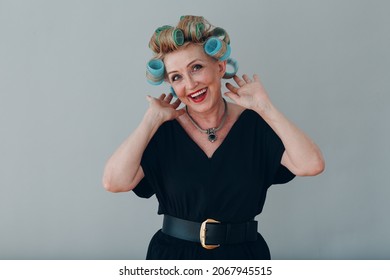 Elderly old aged woman housewife with curlers rollers on hair head.