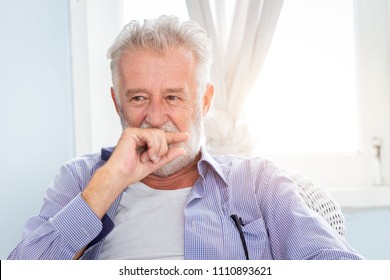 Elderly Old Man Cute Hiding Smile Look Shy Sitting In Room With Window.