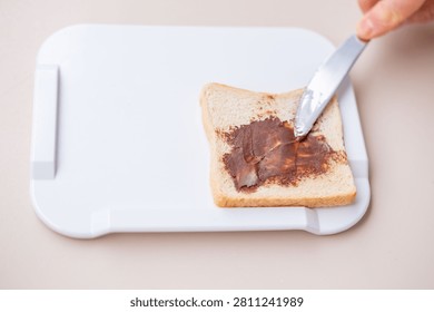 Elderly one-handed man using adaptive non-slip cutting board, independent meal disabled, stroke survivors, arthritis patients in home care, occupational therapy, senior living, food preparation tools
