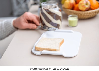 Elderly one-handed man using adaptive non-slip cutting board, independent meal disabled, stroke survivors, arthritis patients in home care, occupational therapy, senior living, food preparation tools