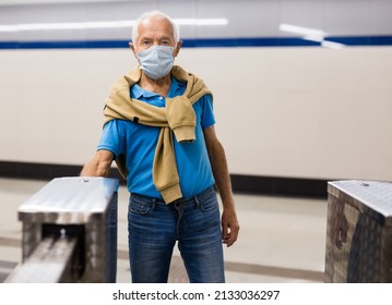 An elderly passenger in a protective mask
