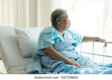 Elderly Patient Alone In Bed. Alone And Stress, Missing Her Grand Children. Looking At Window. Very Senior, Old Chinese Woman.