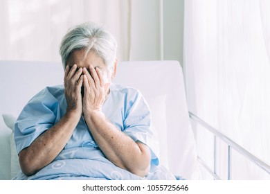 Elderly Patient Alone In Bed. Alone And Stress, Missing Her Grand Children. Hands On Face Pose. Very Senior, Old Chinese Woman.