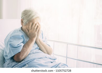 Elderly Patient Alone In Bed. Alone And Stress, Missing Her Grand Children. Hands On Face Pose. Very Senior, Old Chinese Woman.