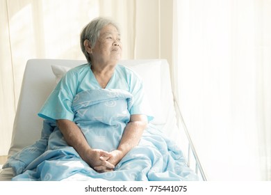 Elderly Patient Alone In Bed. Alone And Stress, Missing Her Grand Children. Looking At Window. Very Senior, Old Chinese Woman.