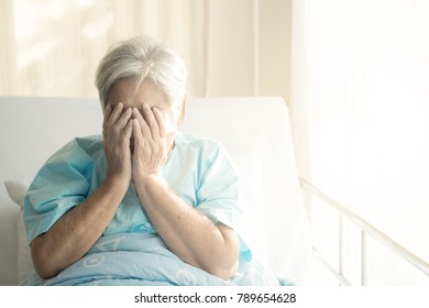 Elderly Patient Alone In Bed. Alone And Stress, Missing Her Grand Children. Hands On Face Pose. Very Senior, Old Chinese Woman.