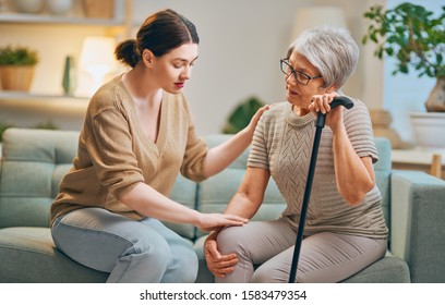 Elderly patient and caregiver spending time together. Senior woman holding cane. - Powered by Shutterstock