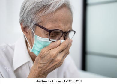 Elderly patient has ill,fever and coughing or sneezing,asian senior woman wearing a mask and isolation,quarantine to prevent the transmission of communicable disease,symptoms of Coronavirus,Covid-19 - Powered by Shutterstock