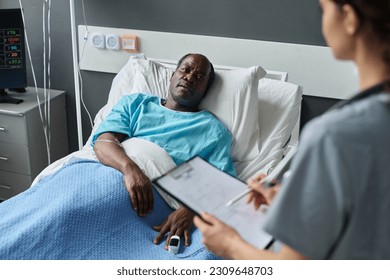 Elderly patient talking to nurse - Powered by Shutterstock