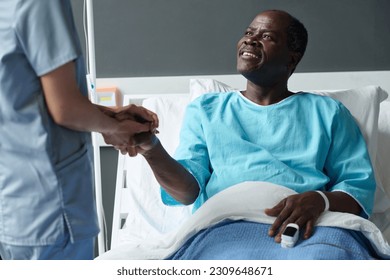 Elderly patient talking to nurse in ward - Powered by Shutterstock