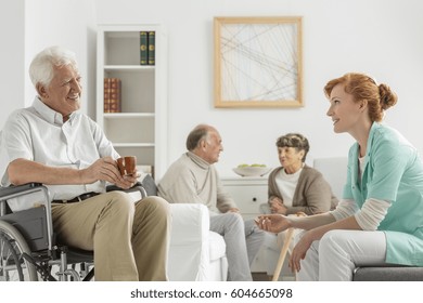 Elderly Patients In Nursing Home Talking With Young Nurse