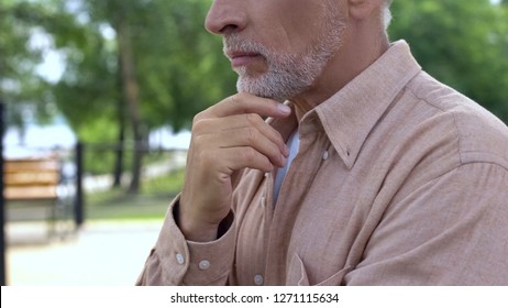 Elderly pensioner thinking of decision, touching gray beard, old age wisdom - Shutterstock ID 1271115634