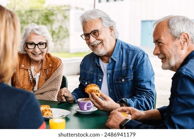 Elderly people enjoying breakfast in the morning at cafeteria bar. Retired group of mature people drinking coffee together on a weekday. Retiree people and friendship concept. - Powered by Shutterstock