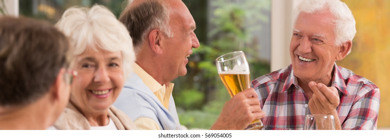 Elderly People Enjoying Grill Party With Beer Outdoor