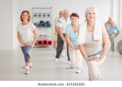 Elderly People Exercising In A Group In Fitness Club