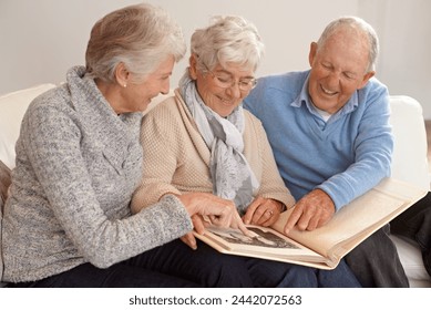 Elderly people, group and together with photo album, living room and pictures with memories, lounge and home. Seniors, smiling and happy in retirement in Canada, pointing and bonding with nostalgia - Powered by Shutterstock